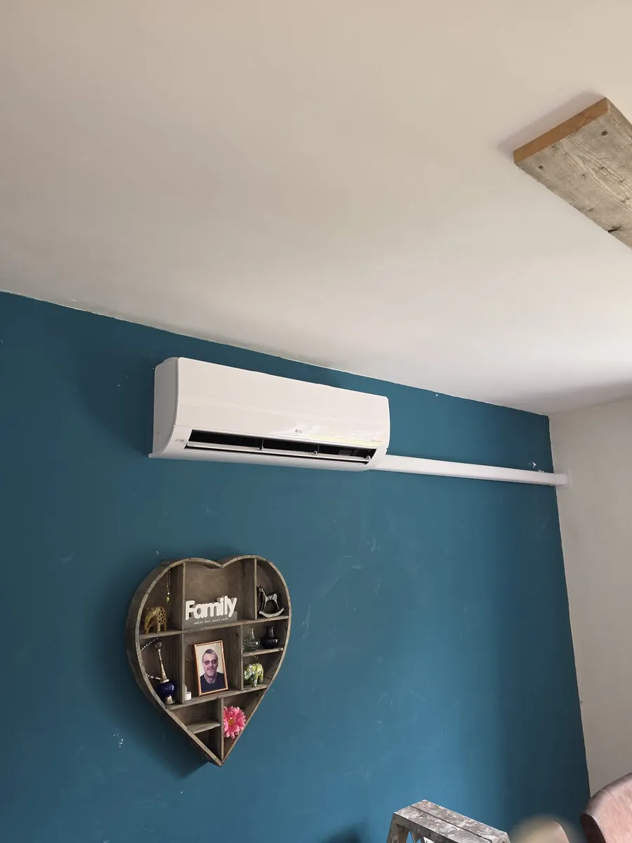 LG binnenunit boven een gekleurde wand